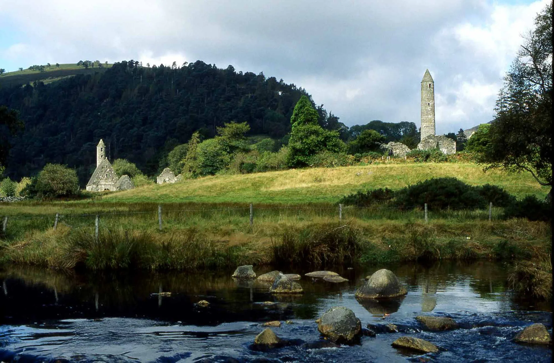 Glendalough valley with river flowing through native oak woodland in the Wicklow Mountains