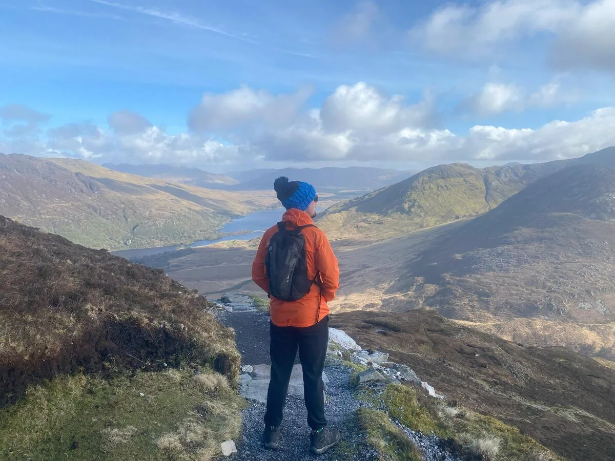 Prepared hiker with proper gear on Diamond Hill trail in Connemara National Park, County Galway
