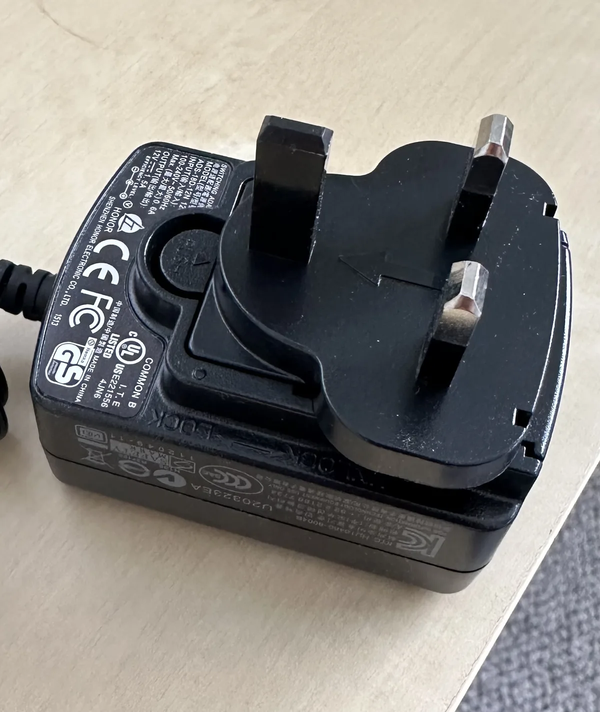 Close-up of a Type G plug with three rectangular pins, the power adapter shape used in Ireland